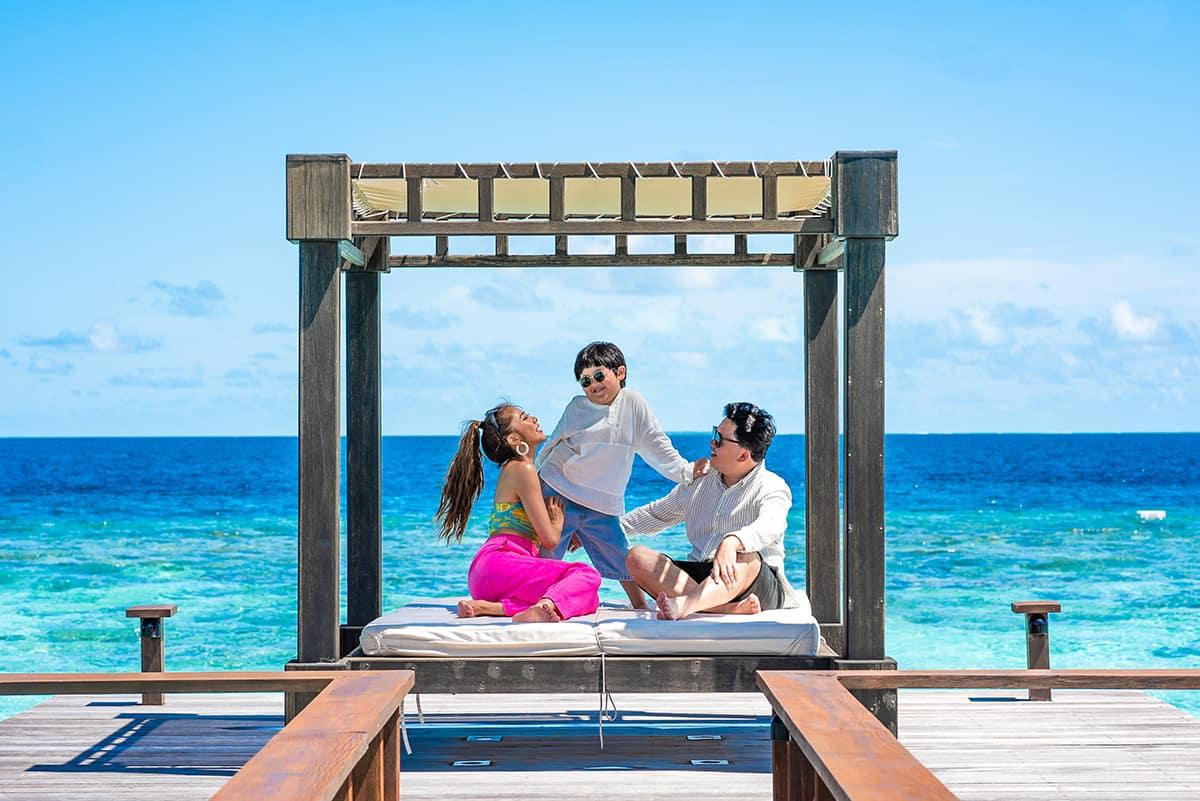Family sitting on thai sala 