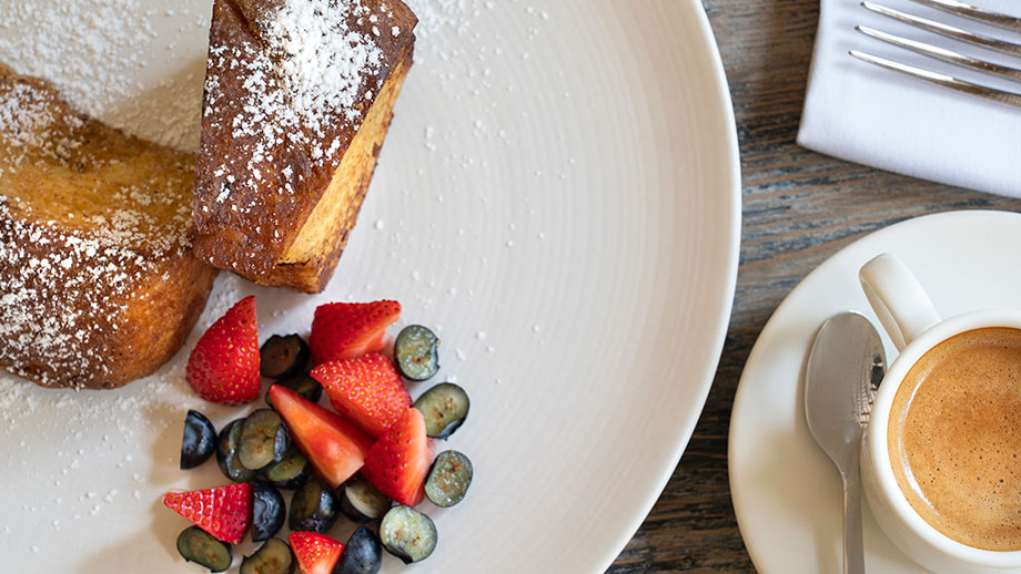 French toast dusted with sugar, berries and espresso in cozy setting at Hacienda Xcanatun, Angsana Heritage Collection.