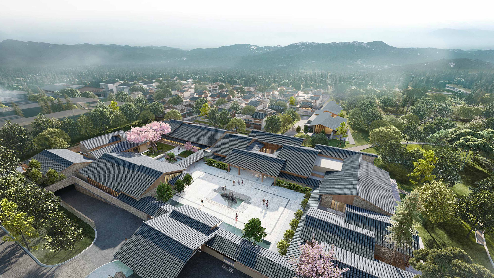 Aerial view of Angsana Chengdu Wenjiang; people stroll courtyard amid green trees, mountains beyond.
