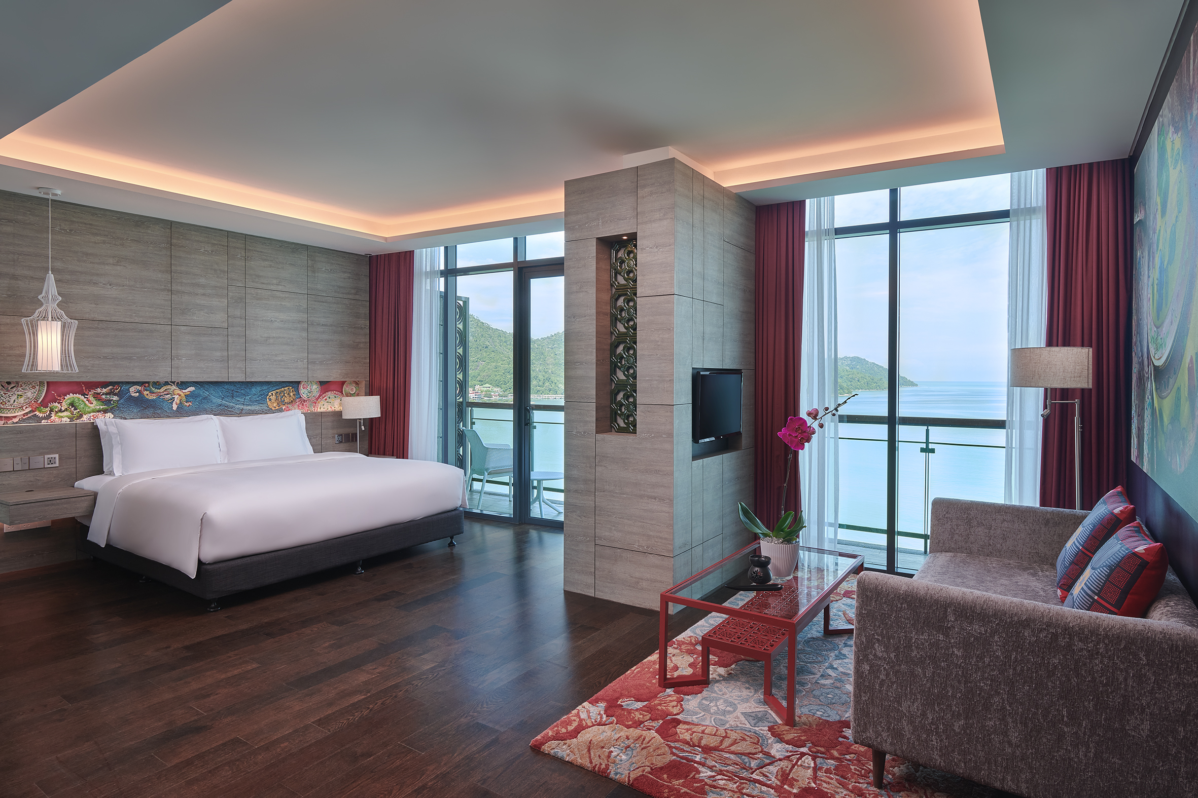 Luxurious room overlooking ocean at Angsana Teluk Bahang Penang with modern decor and plush bed.