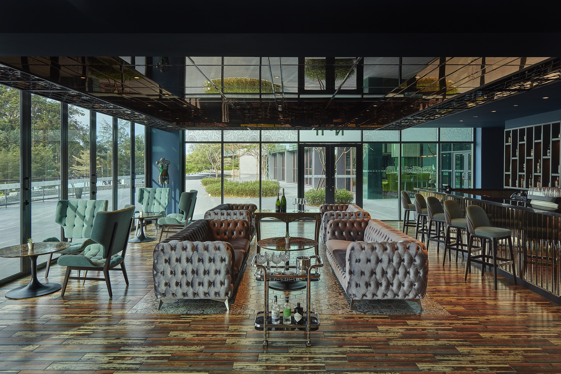 Luxurious lounge seating overlooking garden, Angsana Teluk Bahang Penang. Elegant and airy ambiance.