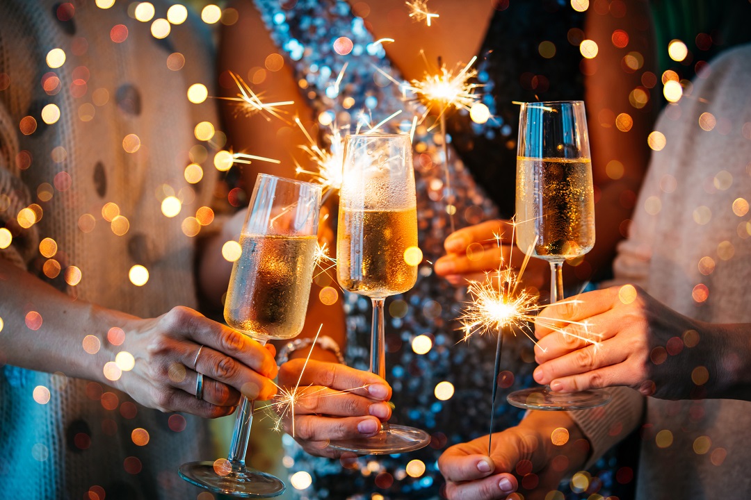 New Year Countdown By The Beach New year celebration, champagne glasses, people celebrating together, countdown