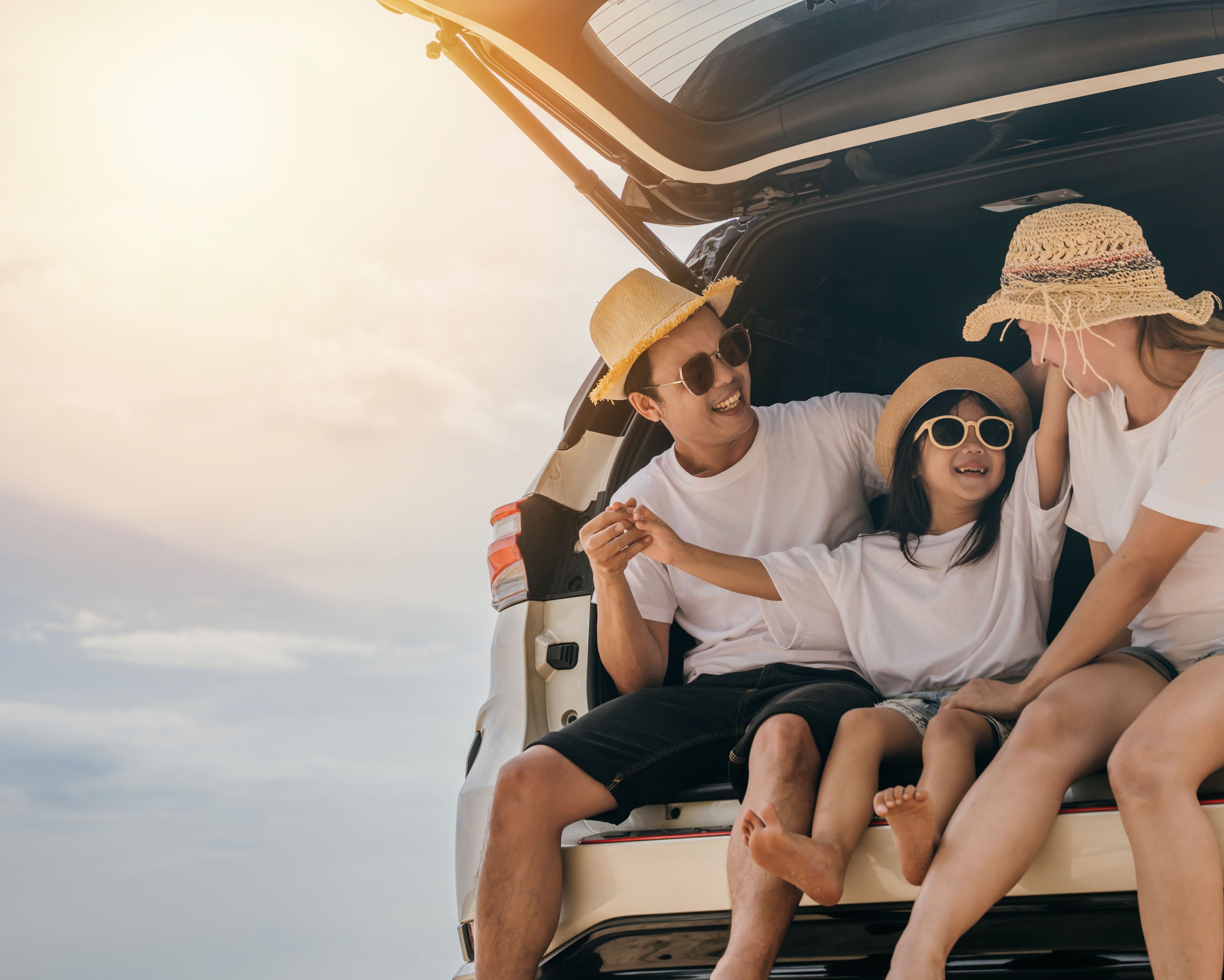 asian family sitting in a car, going on a car trip, a beach vacation, a family road trip to Penang