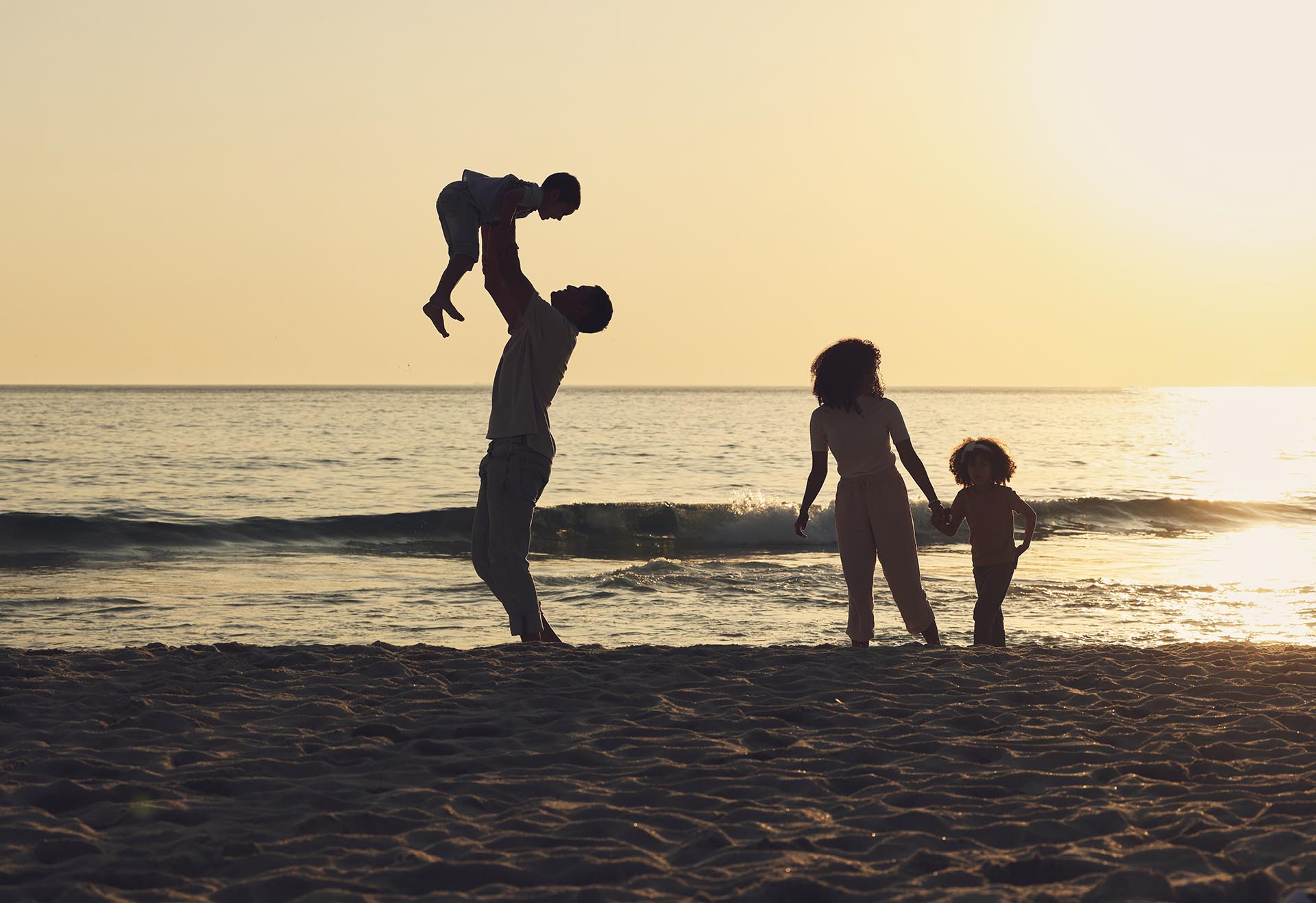 Family enjoying a fun-filled beach vacation at Angsana Velavaru, an all-inclusive resort in the Maldives.