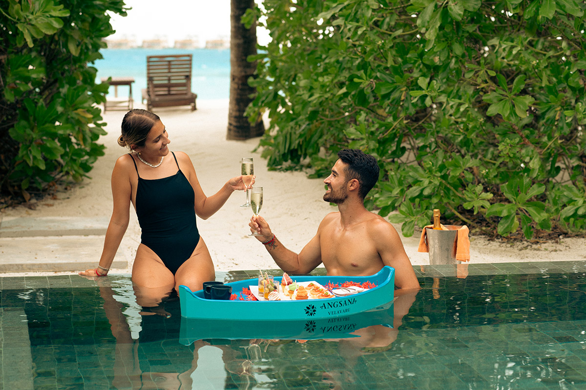 A couple enjoying a floating tea in the their private infinity pool 
