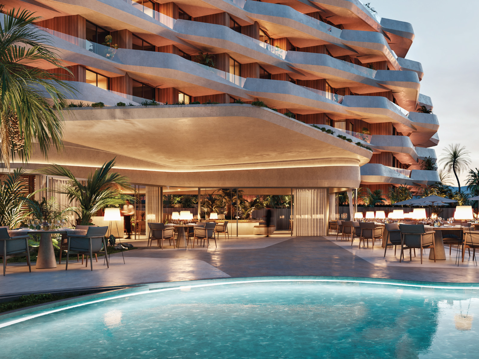 Luxury outdoor swimming pool and modern building architecture at Angsana Cap Cana at dusk